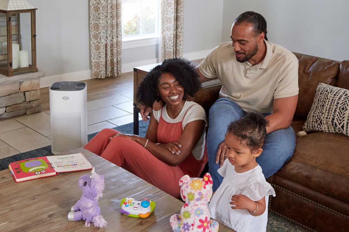 Family posing with Clorox Large Room air filter